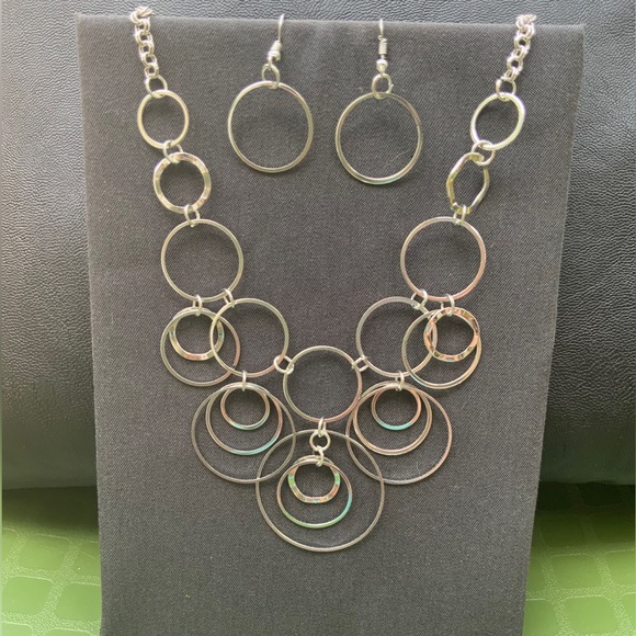 Jewelry - Silver tone, circular layer, necklace with circular earrings.